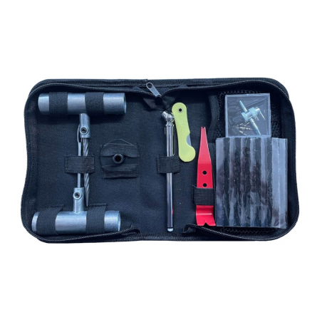 A black zippered tool kit organizer shown open on a white background, containing a metal wrench, a silver tool, a lime green folding tool, a red tool, and a small clear plastic box of valves .Bike Tyre Repair Kit Badger